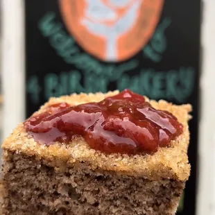 a hand holding a piece of cake