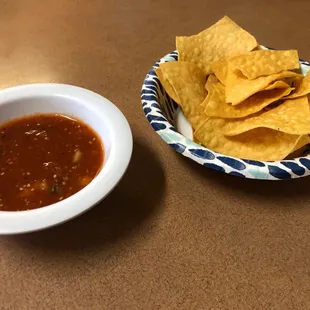 a bowl of salsa and a bowl of tortilla