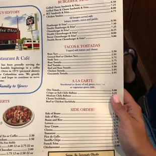 a hand holding a menu