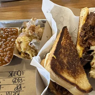 Baked beans, Bread pudding, Burnt Ends on Sourdough with mozzarella and cheddar cheese.