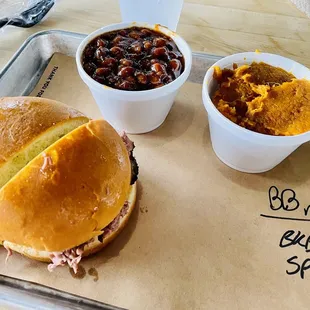 Beef Brisket sandwich with baked beans and sweet potato casserole.
