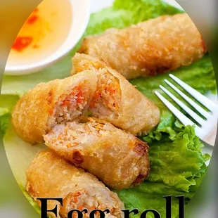a plate of egg roll with lettuce and dipping sauce