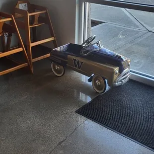 a toy car in front of a window