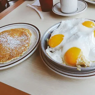 Meatlover&apos;s skillet ($7.25), with bacon + ham + sausage....and 2 double sunny-side eggs on top! Pancakes on the side