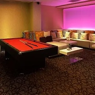 a pool table in the middle of the room