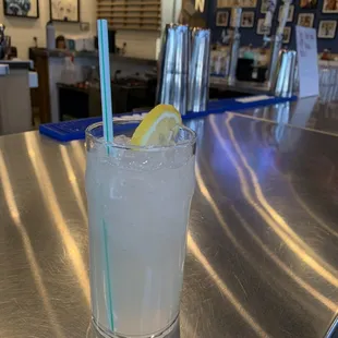 a glass of lemonade on a bar