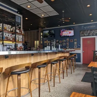 a view of a bar with stools