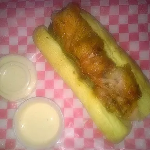 Bacon wrapped Alligator Tail Sandwich with a spicy horseradish sauce.
