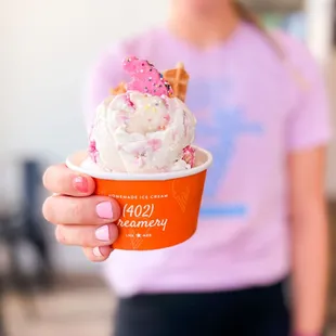 a woman holding a cup of ice cream