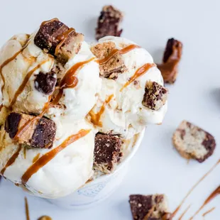 a scoop of ice cream with chocolate chunks and caramel