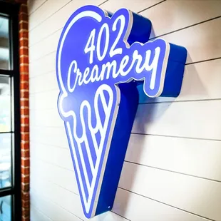 a blue ice cream cone sign