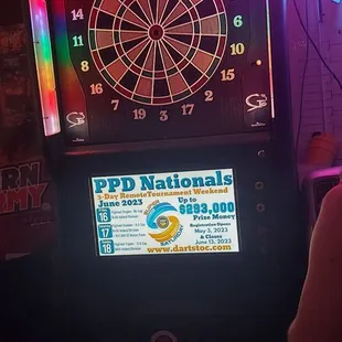 a woman playing a game of darts