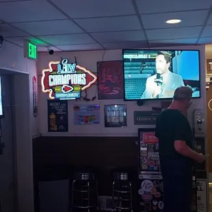 a man standing in front of a television