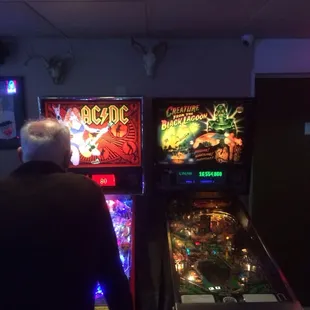 a man playing a game of pinball