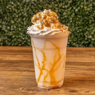 a milkshake topped with whipped cream and caramel