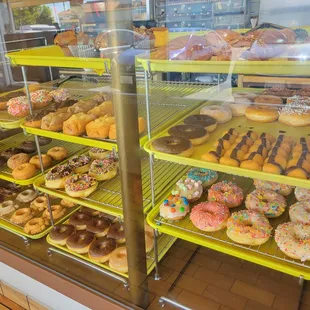 a variety of doughnuts in a display case