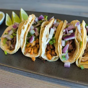 a plate of tacos with salsa