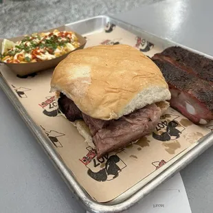 Marbled sliced beef sandwich with elotes and 1/2lb ribs