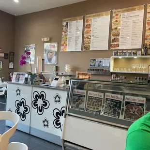 a woman sitting at a table in front of the counter