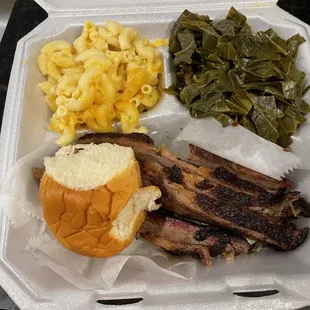 Beef Bisket, greens, macaroni and cheese and roll.