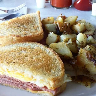 Pork roll (Taylor Ham) egg and cheese on sourdough with home fries. Perfect