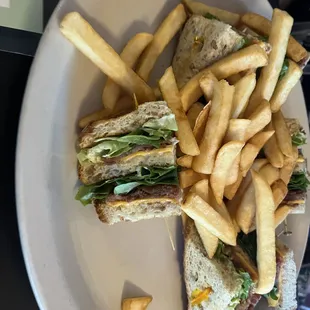 a plate of french fries and a club sandwich