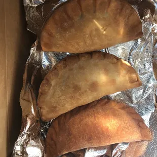 three empanadas in a box