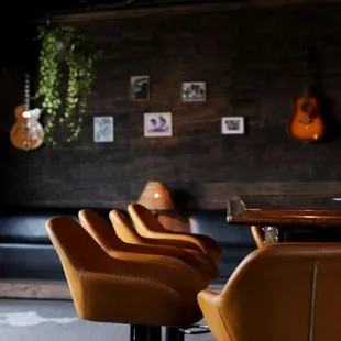 a row of leather bar stools