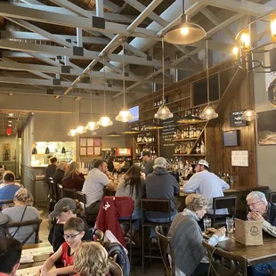 people sitting at tables in a restaurant