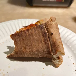 a half eaten pizza on a paper plate