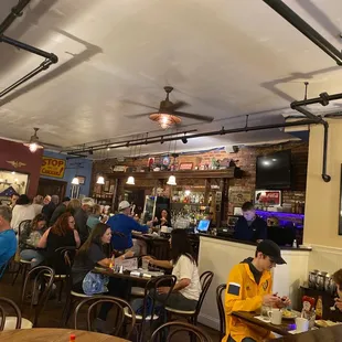 a large group of people sitting at tables in a restaurant