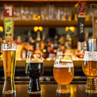 a row of beer glasses on a bar