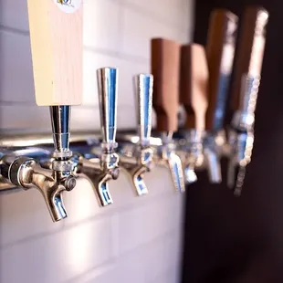 a row of beer taps