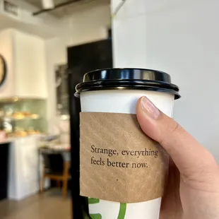 a hand holding a cup of coffee