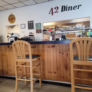 two wooden chairs at the counter
