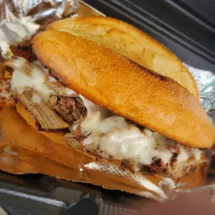 a pulled pork sandwich with melted cheese