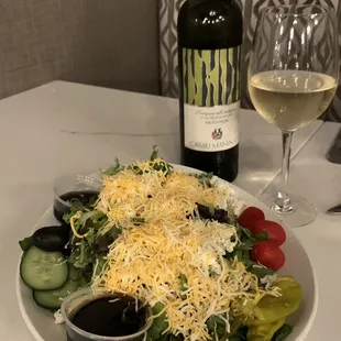 Garden Salad with mixed greens, crumbled Blue Cheese, shredded cheese, Black Olives, Cucumbers, Tomatoes a house Balsamic