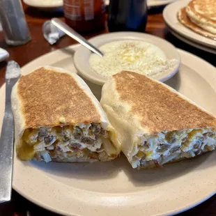 Egg wrap which has sausage cheese onions and hash brown potato's. Side of grits