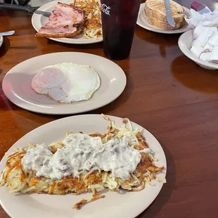 Ham breakfast with hashbrowns, eggs, toast and hashbrowns side with sausage gravy that I put on it.