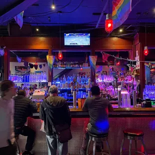 a group of people sitting at a bar