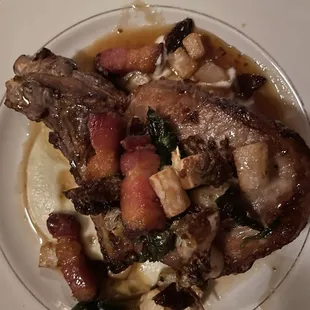 Pork chop with squash , lardons in apple flavored sauce.