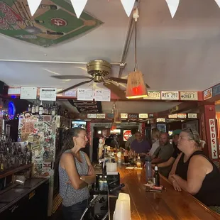 a group of people sitting at a bar
