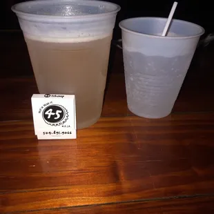 a plastic cup and a plastic cup with a straw