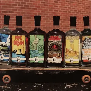 six bottles of liquor on a skateboard