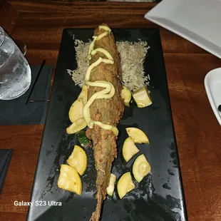 Lightly floured fried fish, quick pickled mixed zucchini and under cooked dry Jasmine rice