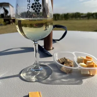 a glass of wine and cheese