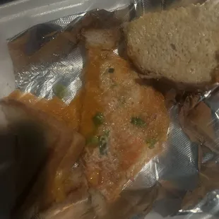 Bread, too much cheese, with onion and lobster paste with 3 tiny pieces of lobster