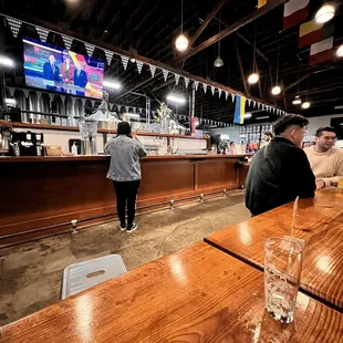 a bar with people sitting at the bar