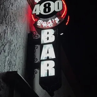 a neon sign on the side of a building