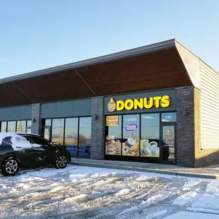 a car parked outside a donut shop
